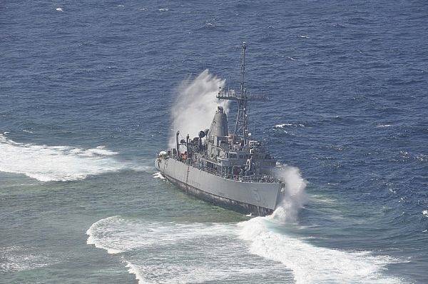 File Waves Break Over USS Guardian: Photo credit USN